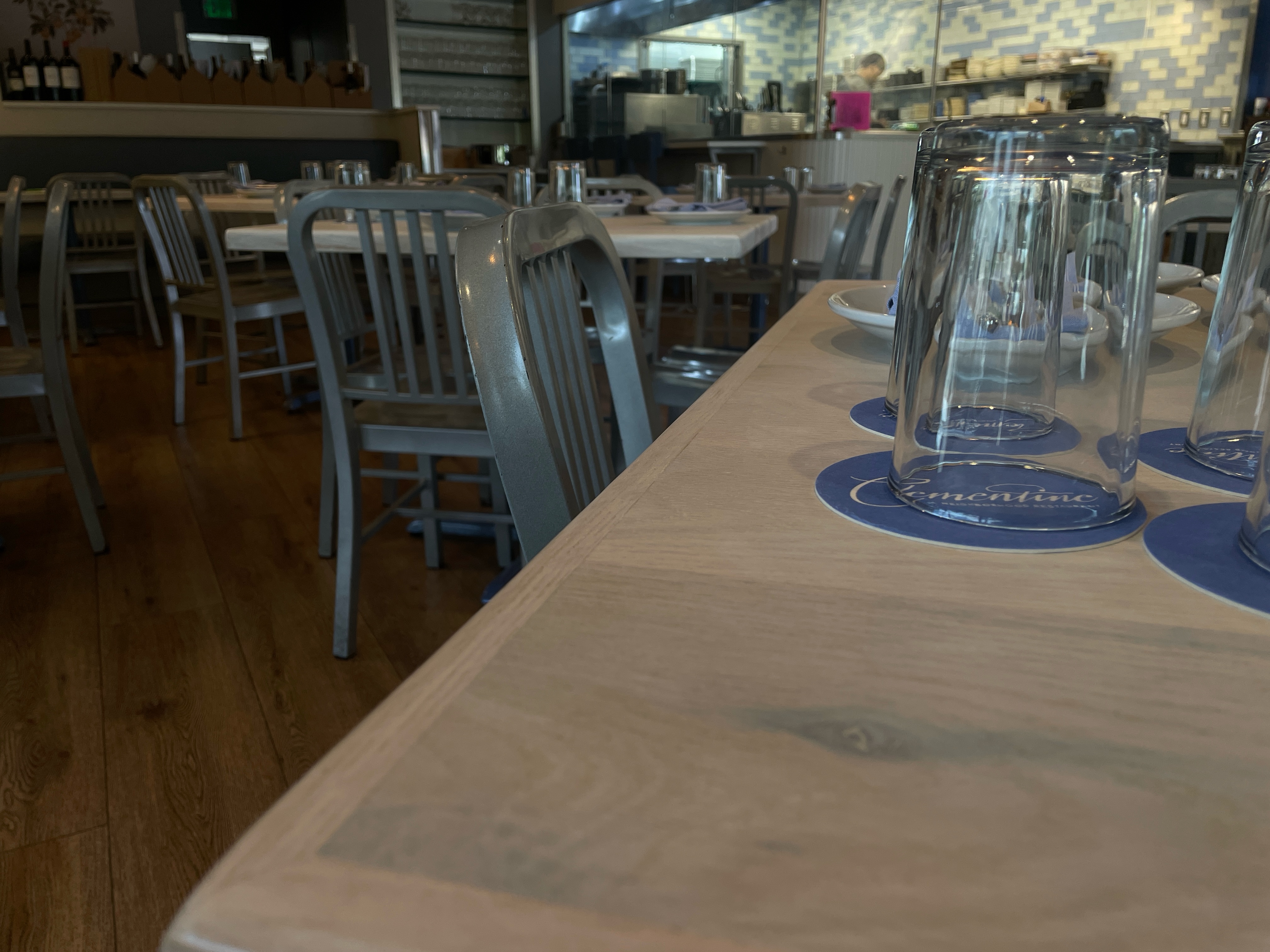 Long communal table refinished, glassware set at Clementine